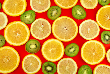 Fototapeta na wymiar Fruit mix- lemon, orange, kiwi on red background