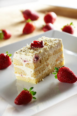Tiramisu cake with strawberry on white plate