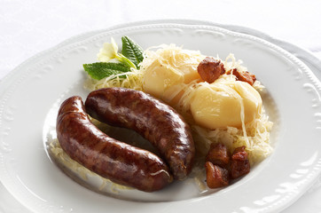 Boiled fresh pork sausage with cabbage, potato and groats