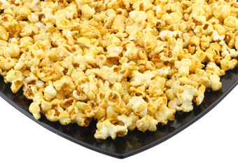 Fragment of plate with fresh caramel popcorn. Isolated