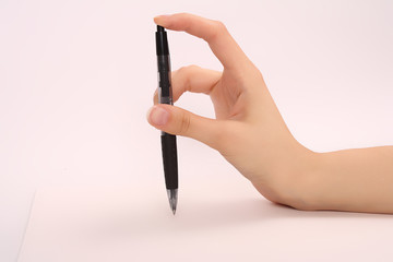 a hand and a pen