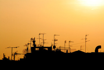 cutout of a sunset on a city roofs skyline