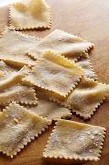 Homemade pasta on wooden desk ready for boiling