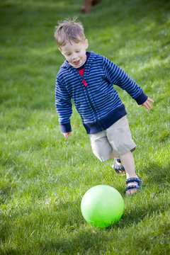 Boy kicking ball