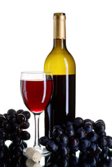 Bottle and glass of red wine with grapes on white backround