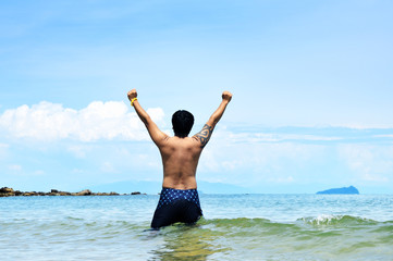 Fototapeta na wymiar ENERGETIC MAN ON THE BEACH