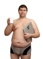 Fototapeta premium overweight man with medicaments and scales