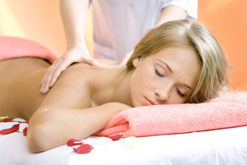 The young beautiful girl has a massage session