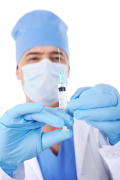 surgeon holding syringe with vaccine