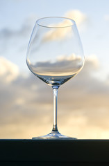 Empty Red Wine Glass Back Lit by the Setting Sun