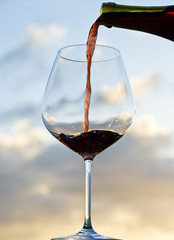 Pouring Red Wine Back Lit by Sunset
