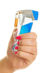 woman rumpling a pack of cigarettes