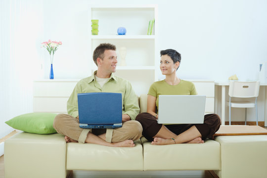 Happy couple using computer