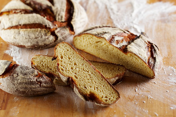 Sliced loaf of bread made of corn flour on wooden desk