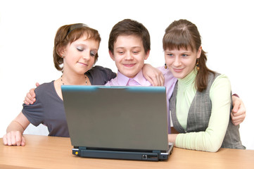 Group of teenagers - pupils having fun on laptop