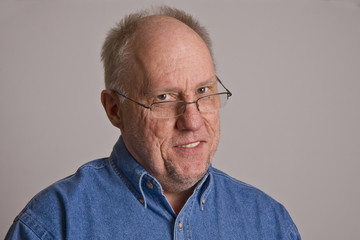 Older Man in Glasses Smiling Head Tilted
