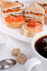 small and club salmon sandwiches and a cup of coffee