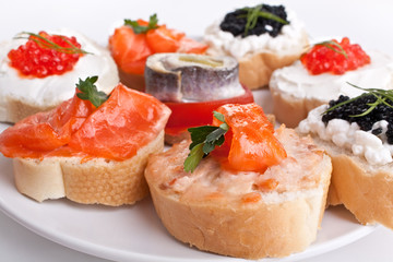 sandwiches with red and black caviar, herring  and salmon