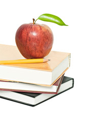 Red apple and pencil on pile of books