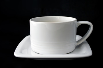 White coffe cup and plate on black background