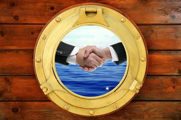 Businessmen handshake view from boat round window