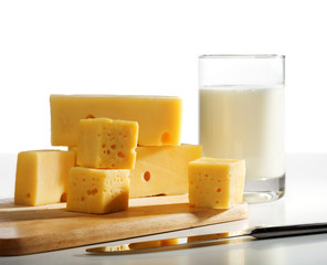 Pieces of cheese and milk glass