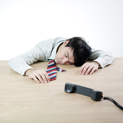 Obraz premium Businessman sleeping on a table
