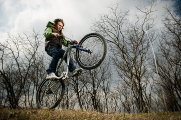 Fototapeta na wymiar Young man riding bike