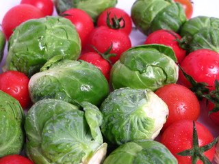 Brussels sprouts and cherry tomatoes, on white background