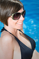 Shot of a Pretty Brunette Girl by the Pool