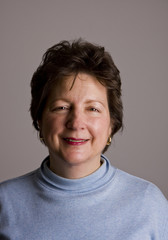 Smiling Woman in Blue on Grey