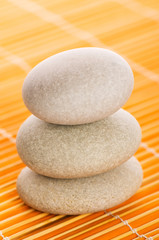 Obraz na płótnie Canvas Stack of spa pebbles against blurred background