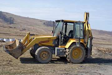 Dirty excavator waiting to flattern the earth