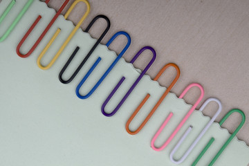Colorful paper clips and note