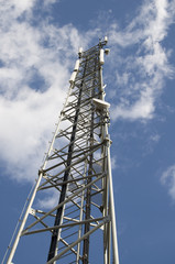 Communications repeater at the cloudy sky