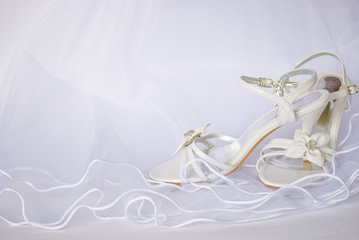 wedding sandals and flowers over veil