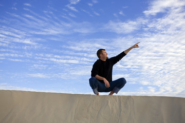 A man pointing to the sky