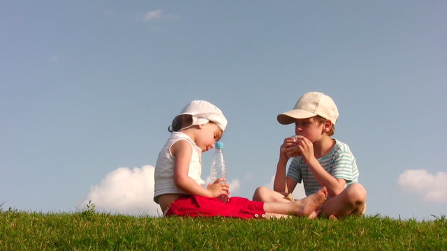 children with food on meadow 2