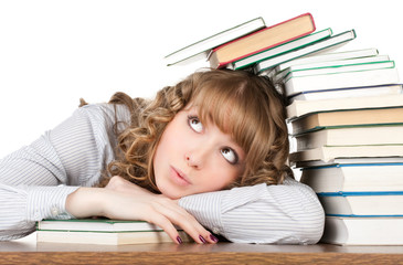 Graceful female student with books looking at camera
