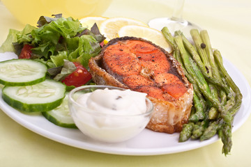 salmon with vegetables, asparagus, lemon and sauce