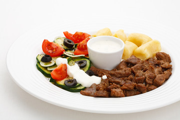 Grilled meat, dumplings and vegetable salad