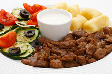 Grilled meat, dumplings and vegetable salad