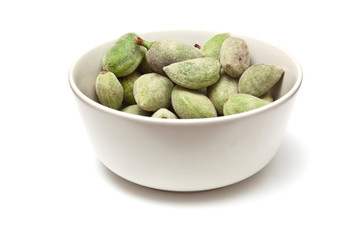 Bowl of fresh green almonds