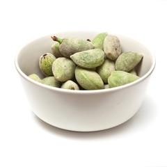 Bowl of fresh green almonds