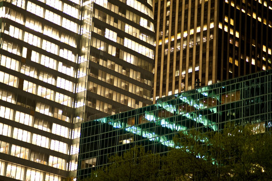 Urban buildings reflected in the glass windows of skyscrapers.
