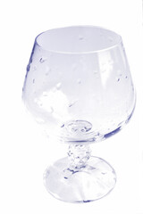 Glass cup with water droplets in the violet tone