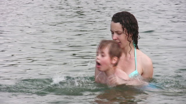 mother teaching boy swim