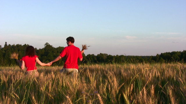 behind couple in wheat field