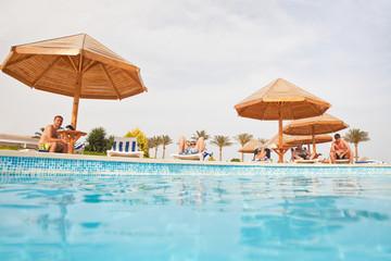 People resting near swimming pool