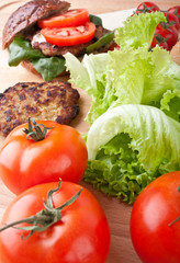 cheeseburger and ingredients for another burger